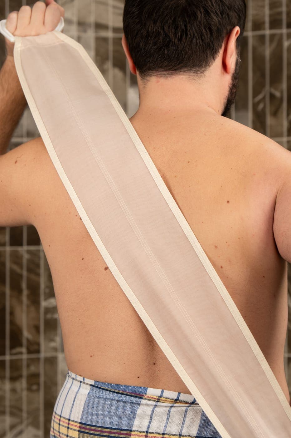 Close-up of the natural raw Turkish cocoon silk back scrubber strap, showing its sheer woven fibre