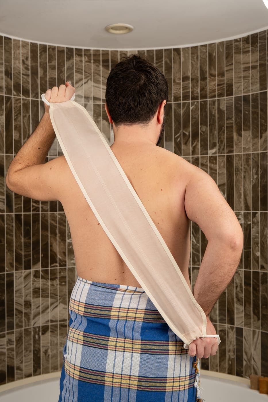 The Turkish hammam ritual with the natural raw cocoon silk back scrubber strap and a traditional peştemal