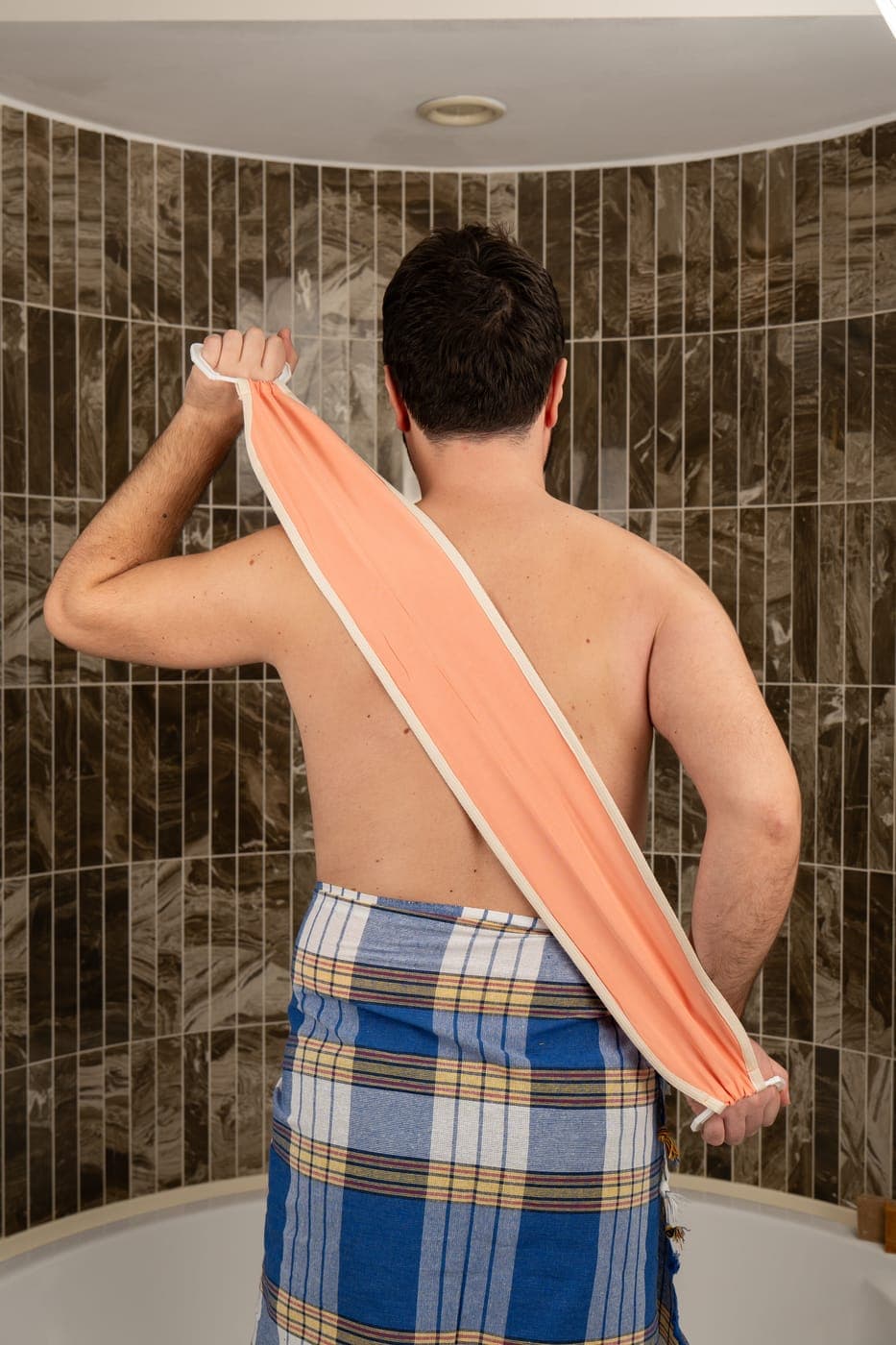 The salmon pink vegan plant silk back strap gliding across a smoother, brighter back